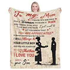 a woman holding up a blanket with the words to my mom