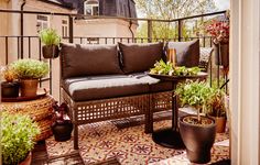 a balcony with potted plants on it and a bench in the foreground,