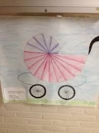 a child's drawing of a stroller hanging on the wall