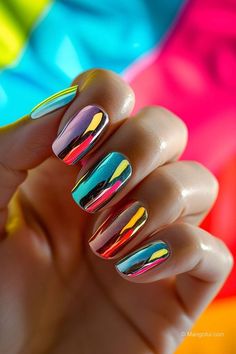 a woman's hand with multicolored nail polish on her nails and colorful background