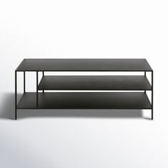 a black coffee table sitting on top of a white floor