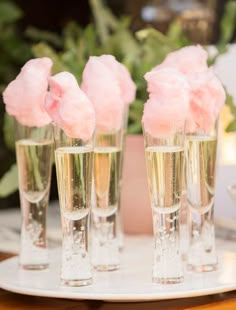 four champagne glasses filled with pink flowers on top of a white tablecloth and text that reads instagram