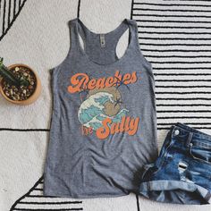 Retro Inspired Beaches Be Salty Women's Racerback Tank to is perfect for your beach vacation or just hanging poolside all summer long! Makes a great gift! Looking for additional outdoor apparel? Check these out: https://www.etsy.com/shop/TheGraphicPeach?ref=seller-platform-mcnav§ion_id=31675954 Our shop uses direct-to-garment printing to make our products. The design ink is sprayed on, then allowed to soak into the fibers of the garment. This process yields fine quality prints and a smooth finis Stretch Racerback Tank Top For Vacation, Summer Racerback Tank Top For Vacation, Summer Tank Top For Poolside And Beach Season, Casual Vacation Tank Top For Poolside, Casual Tank Top For Poolside Vacation, Casual Vacation Poolside Tank Top, Casual Tank Top For Beach Party Vacation, Casual Tank Swimwear For Summer, Racerback Swimwear For Surfing In Summer