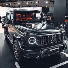 the mercedes g - class is on display at an auto show