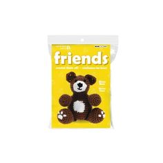 a brown and white teddy bear sitting in front of a package of friends stickers