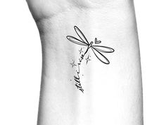 a black and white photo of a dragonfly tattoo