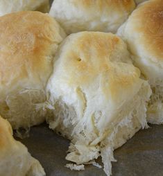 several rolls are cut in half on a baking sheet