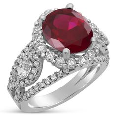 an oval shaped ruby and diamond ring with two rows of pave set diamonds surrounding the band