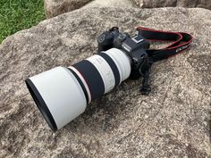 a camera lens sitting on top of a rock