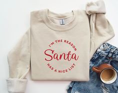 "Santa Sweatshirt, Santa Shirt, Retro Santa Shirt, Christmas Sweatshirt, Women Christmas Santa Shirts, Cute Vintage Santa Shirt, Classic Christmas Shirt, Christmas Pullover, Santa Sweatshirt, Retro Pink Santa Hat Sweater, Classic Christmas Santa, Vintage Santa Graphic Sweatshirt, Holiday Sweater Funny Santa Sweatshirt \"I'm The Reason Santa Has A Nice List\" Available on White, Sand, or Sport Grey Thank you for shopping with Fire Creek Mercantile, Merry Christmas! Ideal for any situation, a unis Pink Santa Hat, Santa Graphic, Holiday Clothing, Mama Sweater, Christmas Pullover, Holiday Outfits Women, Pink Santa, Santa Sweatshirt, Retro Santa