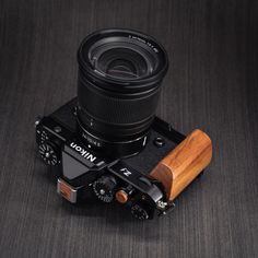 a camera with a wooden case and lens