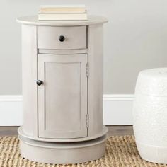 a white cabinet sitting on top of a rug