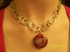 a woman wearing a coca cola bottle necklace