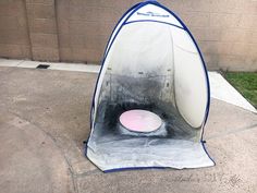 a white and blue surfboard sitting on top of a cement floor next to a building