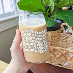 a person holding up a glass with some type of drink in it's hand