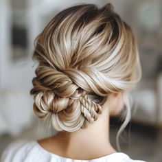 a woman with blonde hair in a braid updo