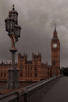 the big ben clock tower towering over the city of london on a gloomy day