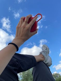 a person holding a red object in their hand