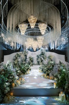 an elaborate wedding setup with chandeliers and flowers