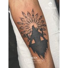 a man with a black and grey tattoo on his arm that has an image of a person holding a flower