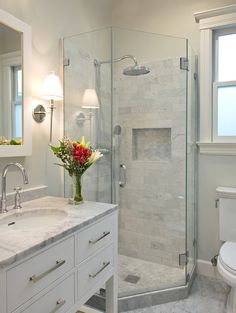 a bathroom with a shower, sink and toilet