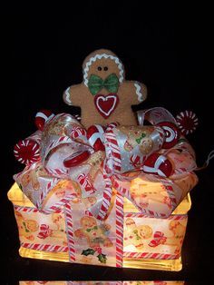 a lighted gingerbread gift box with candy canes