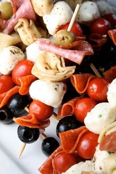 an assortment of meats and vegetables on skewers