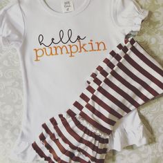 Hello Pumpkin embroidered in brown and orange on white long or short sleeve ruffle tee with coordinating brown striped ruffle pants. Tee also available separately. Sizes 12m to 10 Ruffle Pants Outfit, Girls Western Wear, Girls Valentines Outfit, Western Girl Outfits, Hot Pink Shirt, Girls Halloween Outfits, Girls Thanksgiving, Hello Pumpkin, Ruffle Pants