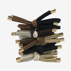 # Pieces In Set: 5Included: 3 Hair Tie(s)Measurements: 1.5 Length/Inches, 1.5 Width/InchesBase Material: 100% PolyesterCare: Wipe CleanHair Good Type: PoniesCountry of Origin: Imported Black And Gold Hair, Gold Hair, Hair Tie, Accessories Hair, Hair Ties, Black And Gold, Gold Tones, Hair Accessories, Bar