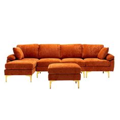 an orange sectional sofa with gold legs