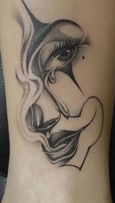 a woman's foot with a black and white tattoo design on the side of her leg