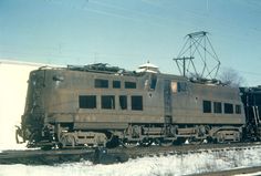 an old train is sitting on the tracks in the winter time, with no people around it