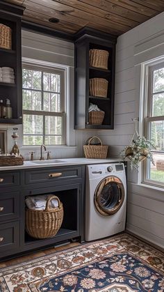 a washer and dryer in a small room with windows, rugs and cabinets