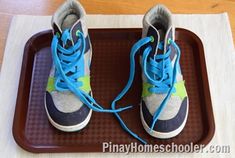 a pair of shoes sitting on top of a scale with blue and green laces