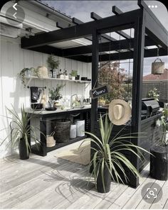 an outdoor area with potted plants and shelves