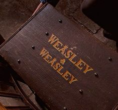 a wooden chair with the words weasely and weasley written on it