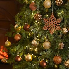 a christmas tree decorated with gold and silver ornaments