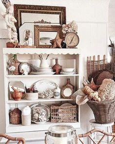 a white shelf filled with lots of different types of dishes and decor on top of it