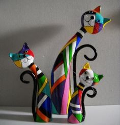 two colorful cat figurines sitting next to each other