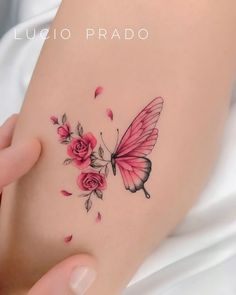 a woman's arm with pink roses and a butterfly tattoo on her left side