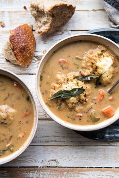 two bowls of soup with bread on the side