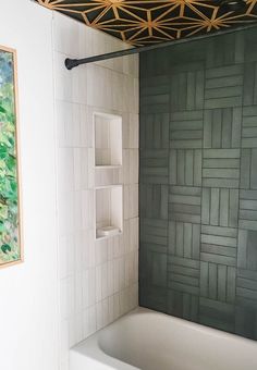 a white bath tub sitting under a wooden ceiling next to a painting on the wall