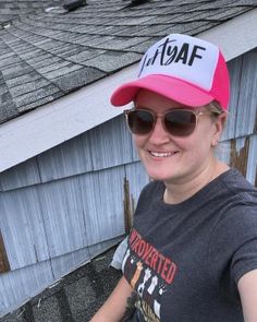 a woman wearing a pink hat and sunglasses