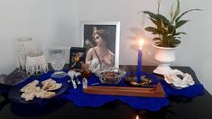 a table topped with plates and candles next to pictures