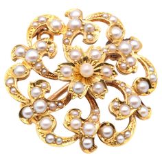 An Edwardian, pearl, and yellow gold brooch, comprising sixty half seed pearls, and one whole seed pearl, set in 15 karat yellow gold, with 15 karat yellow gold pin and fittings. This delightful Edwardian jewel is wearable as both a pendant and a brooch. The piece is centred around a 6-petaled flower with a whole seed pearl at the centre. The flower is surrounded by scrolling foliate motifs, creating an elegant open design. The piece is complete with a roller ball safety catch and pin in yellow Antique Rings Vintage, Art Nouveau Pendant, Victorian Gold, Pin Pendant, Nature Inspired Jewelry, Gold Brooches, Pearl Set, Seed Pearl, Victorian Jewelry