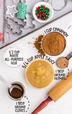 ingredients to make homemade gingerbread cookies laid out on a baking sheet with cookie cutters