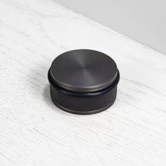 a black container sitting on top of a white table