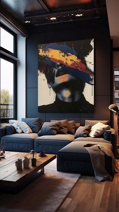 a living room filled with furniture and a large painting on the wall above it's windows