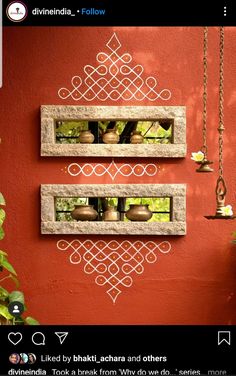 two stone shelves are hanging on the side of a red wall with pots and vases in them