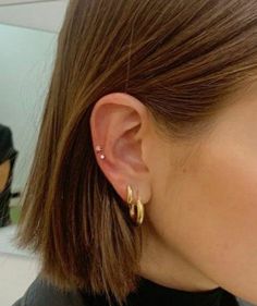 a close up of a person wearing ear piercings